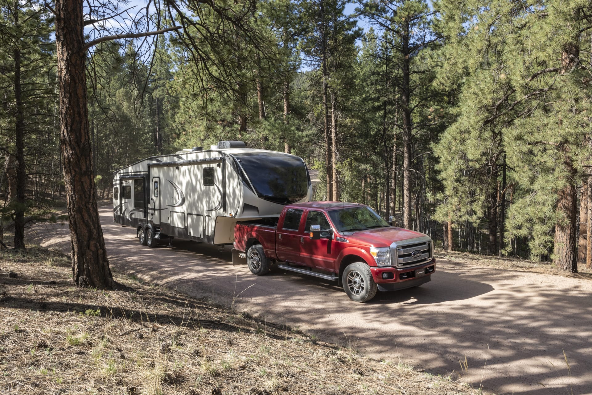 Ford F-250 Towing 5th Wheel Camper Forest Road